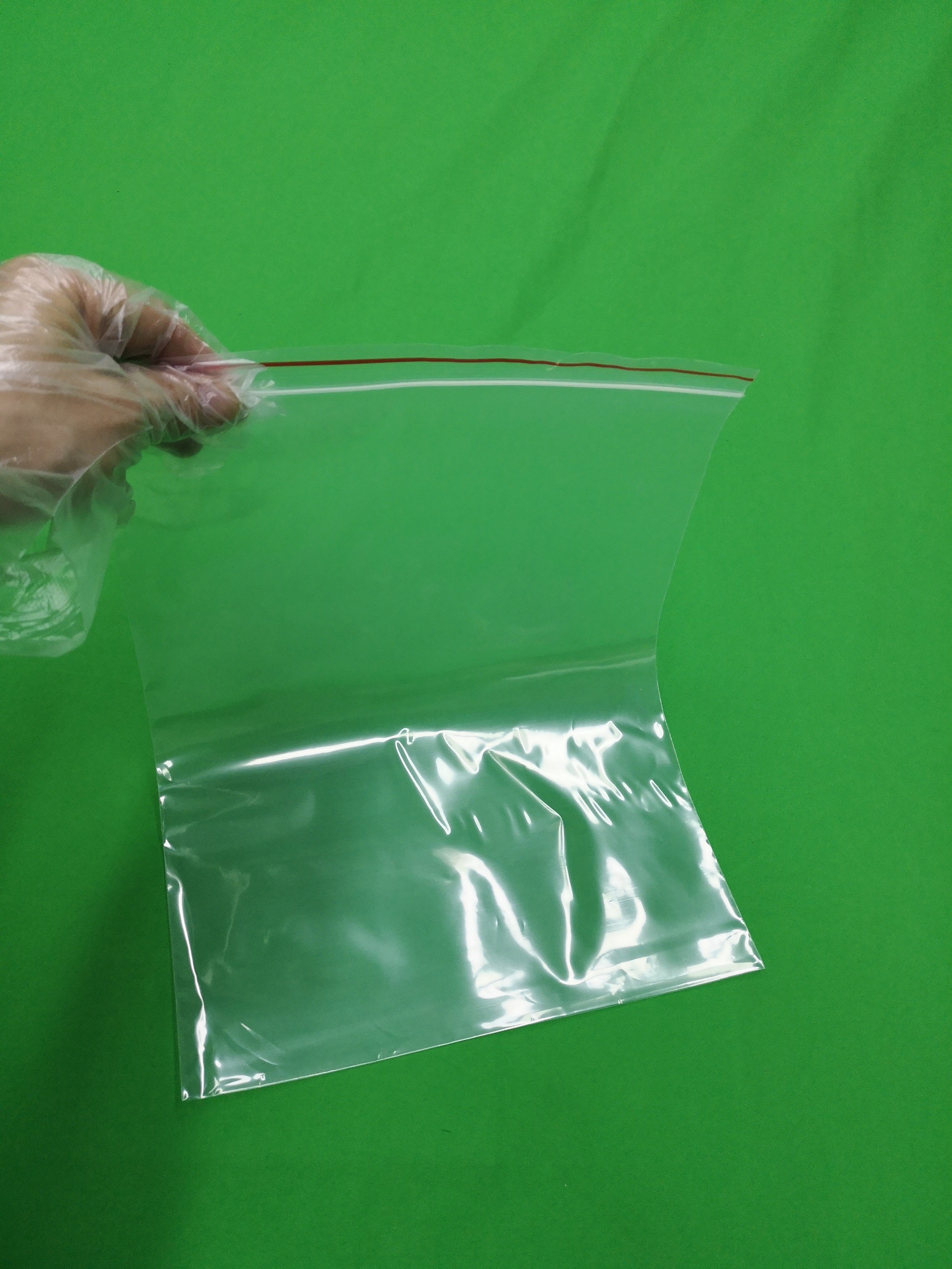 Clear plastic ziplock bag with red line, size 250x345x0.060mm, reclosable