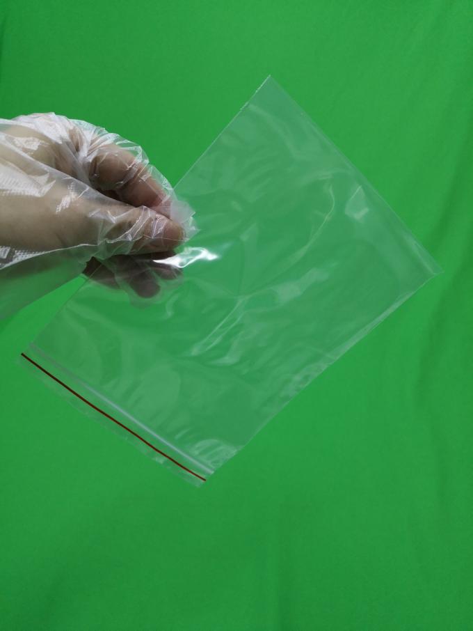 Transparent plastic ziplock bag with red line, size 140x200x0.055mm